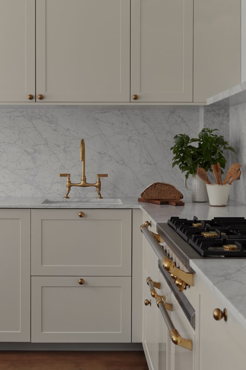 A close-up of a sophisticated kitchen featuring marble countertops